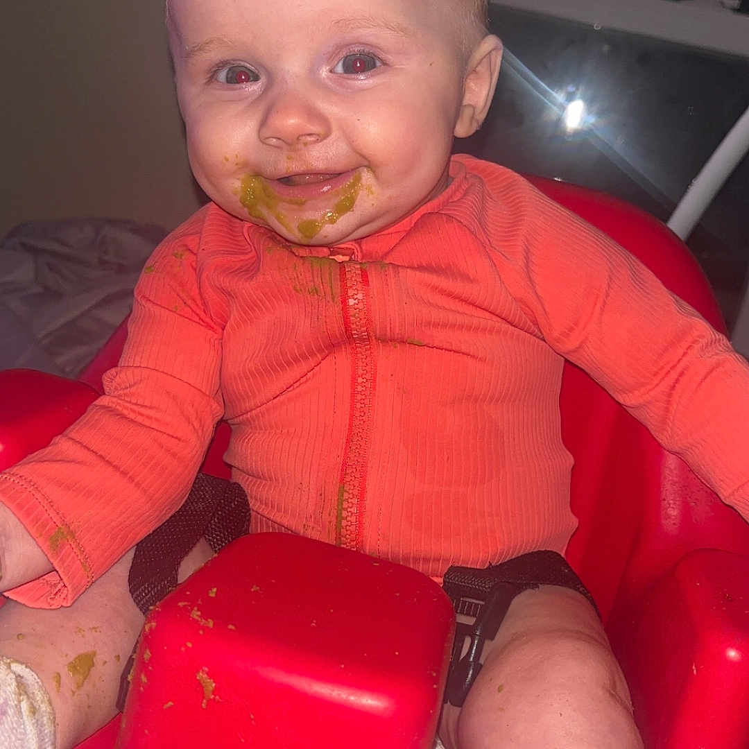 Emma joined the competition — help win amazing prizes! baby, bodypart, chair, clothing, coat, couch, cushion, cutlery, face, finger, furniture, hand, head, homedecor, jacket, person, photography, portrait, sitting, toy