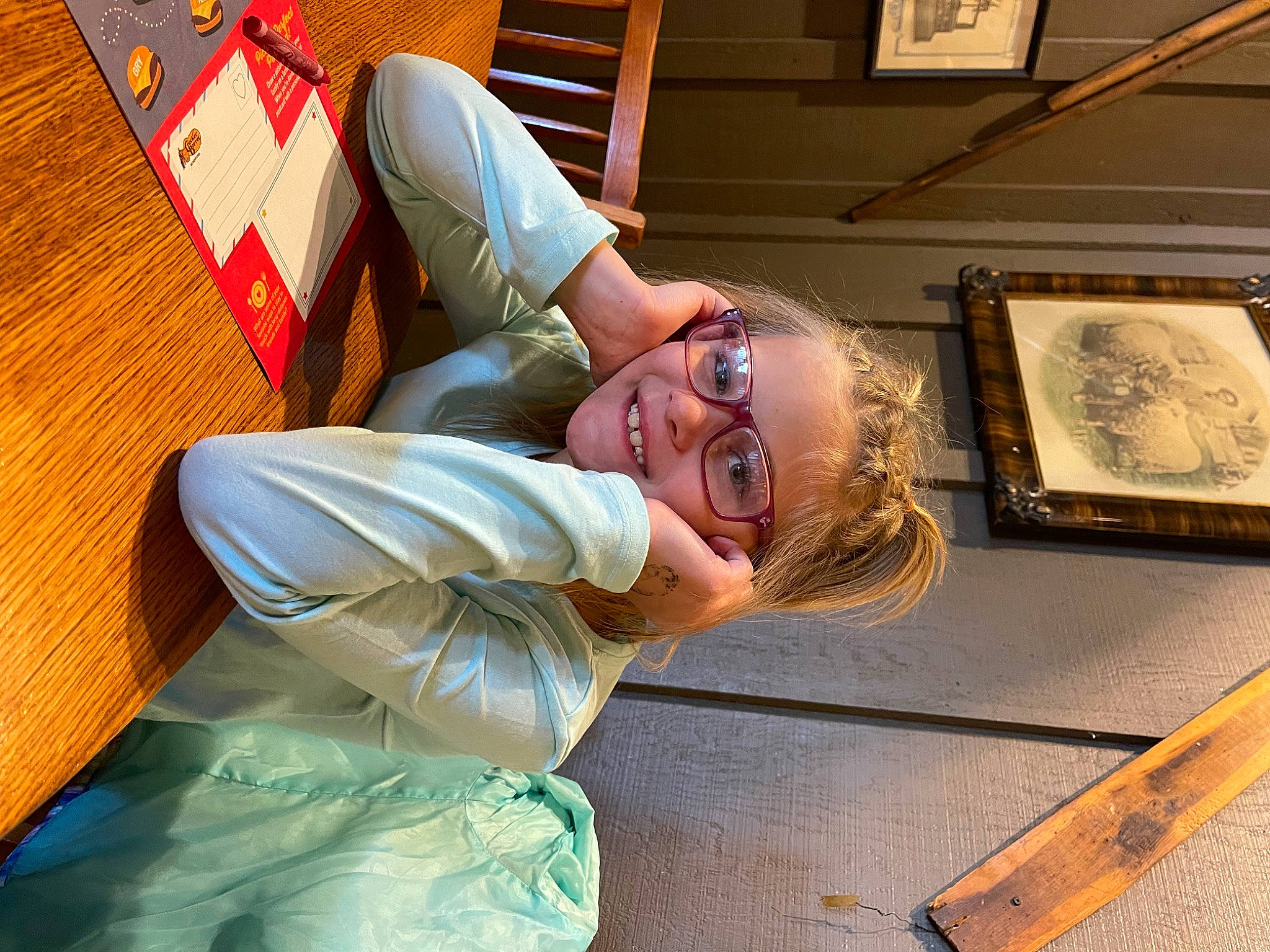 Kendhyl is registered to the contest to win money with this photo: child, event, eyewear, fun, glasses, happy, joy, leisure, person, picture_frame, room, sitting, smile, sunglasses, vision_care, wood