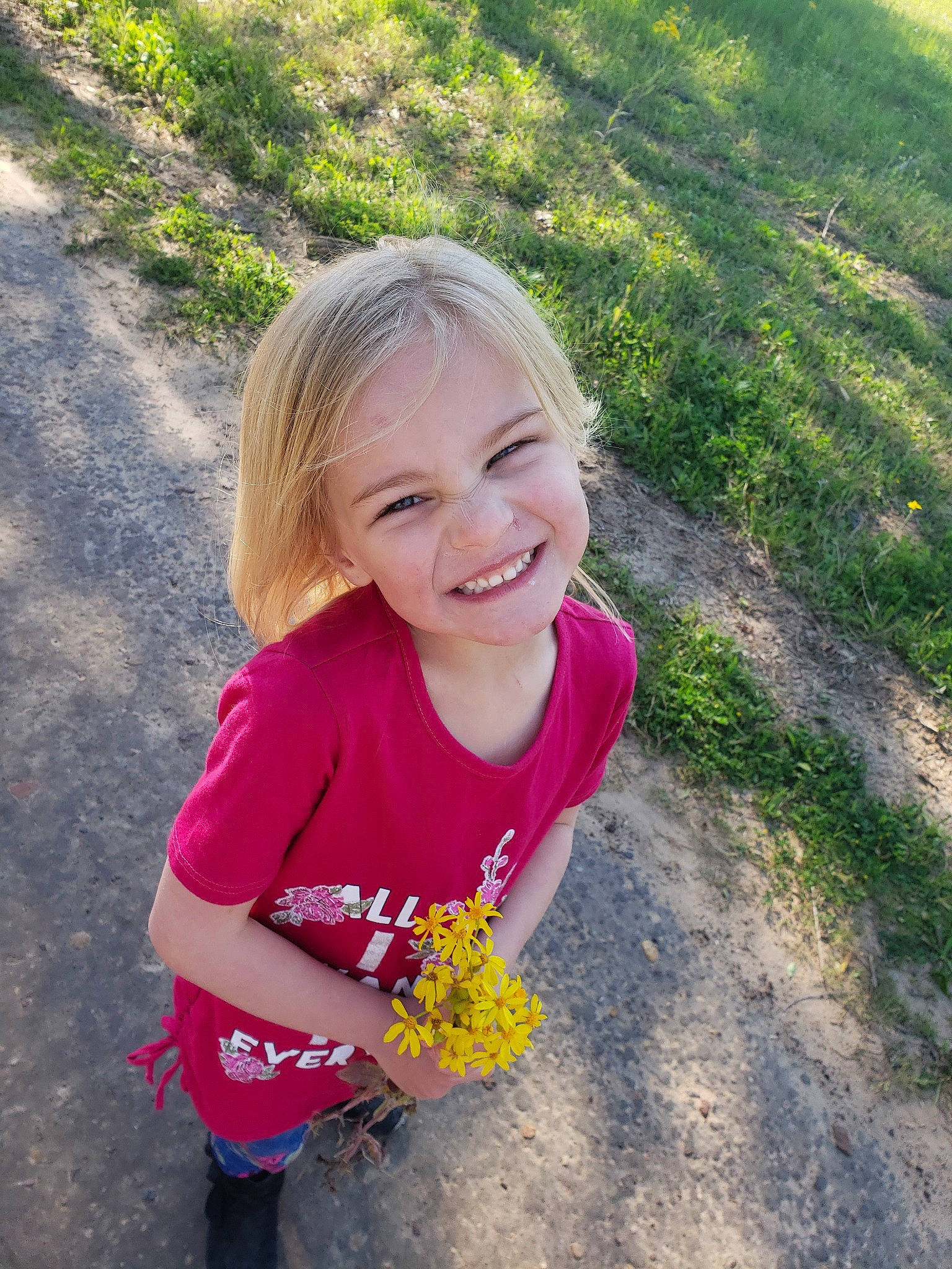 Kendhyl is registered to the contest to win money with this photo: botany, child, facial_expression, flower, fun, grass, happy, joy, leaf, people, person, plant, play, smile, spring, summer, toddler, vacation, wildflower, yellow