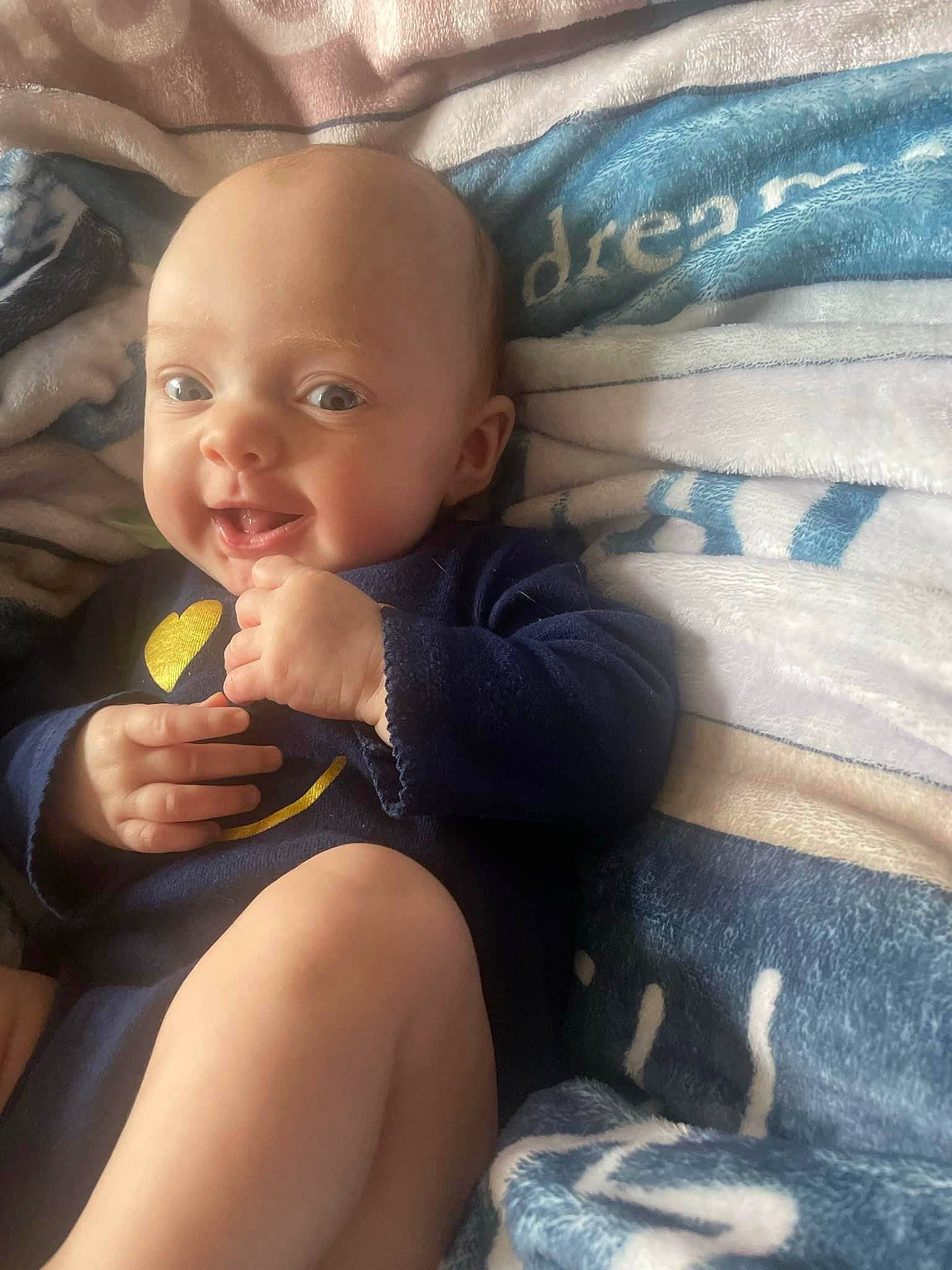 Sophia is registered to the contest to win money with this photo: baby, baby_toddler_clothing, cheek, child, comfort, eye, finger, happy, human_body, iris, lap, leg, lip, mouth, person, skin, smile, textile, thigh, thumb