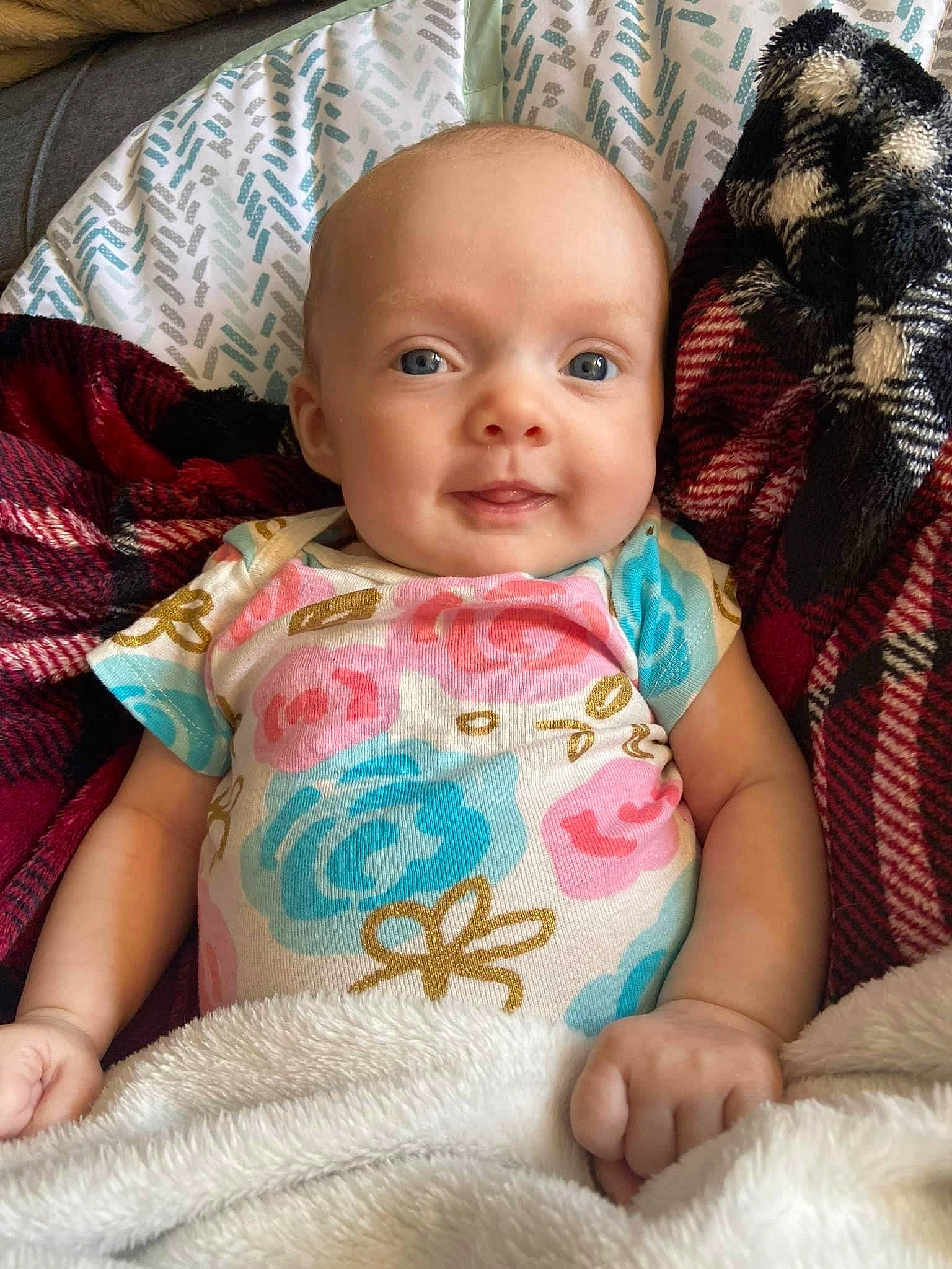 Sophia is registered to the contest to win money with this photo: arm, baby, baby_toddler_clothing, cheek, chin, comfort, eye, eyebrow, facial_expression, head, iris, mammal, mouth, nose, organ, person, pink, skin, sleeve, smile