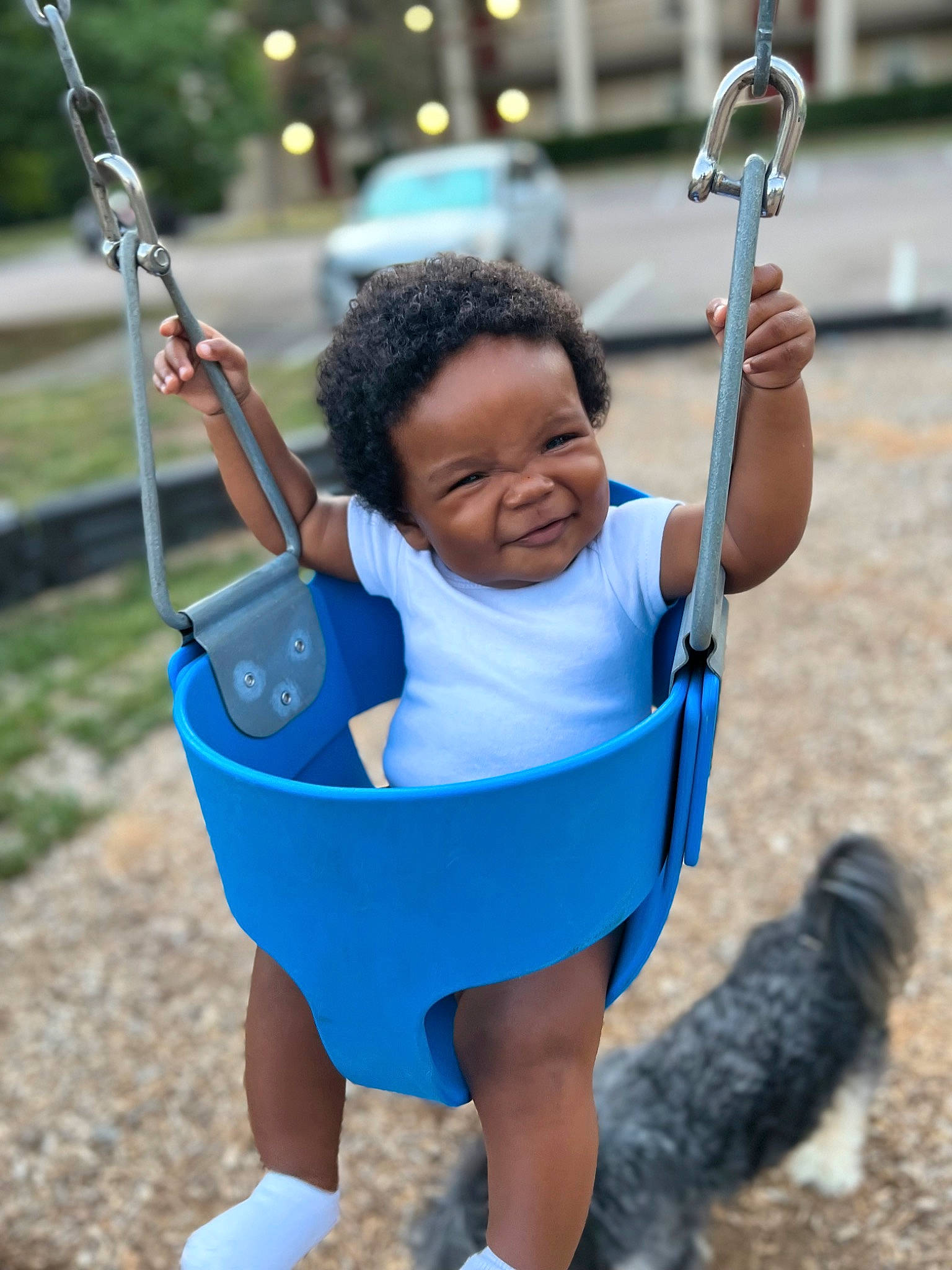 Mael is registered to the contest to win money with this photo: azure, beauty, electric_blue, fun, hand, happy, leisure, outdoor_play_equipment, people_in_nature, person, photograph, plant, playground, public_space, recreation, summer, swing, toddler, tree, white