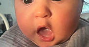 Rosie joined the competition — help win amazing prizes! baby, face, expression, wide_eyes, blanket, indoors, child, portrait, cute, surprised, toddler, soft_light, clothing, head, skin, hair, mouth, closeup, person, infant