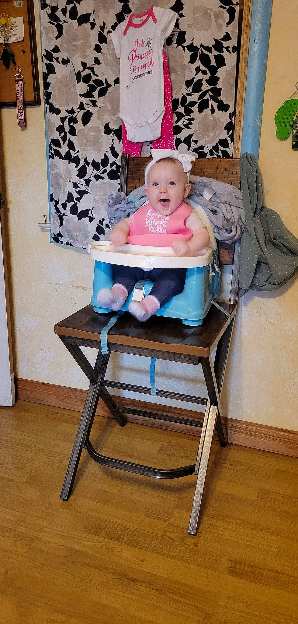 Breleigh is registered to the contest to win money with this photo: baby, baby_products, baby_toddler_clothing, chair, child, comfort, flooring, folding_chair, furniture, hardwood, laminate_flooring, peach, person, plant, room, rose, shorts, sitting, toddler, wood