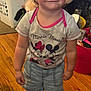 Addison joined the competition — help win amazing prizes! toddler, child, pink_bow, headband, minnie_mouse, tshirt, shorts, shoes, indoor, wooden_floor, laundry_basket, stuffed_animal, smiling, person, clothing, toy, home, cute, standing, happy