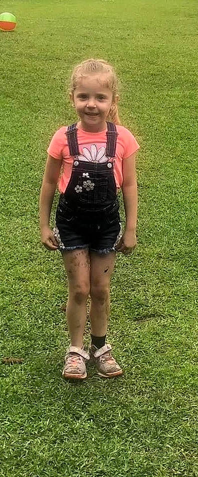 Brooklynn is registered to the contest to win money with this photo: bag, denim, face, gesture, grass, hair, happy, joy, knee, lawn, leg, luggage_and_bags, people_in_nature, person, shorts, sleeve, smile, sportswear, t_shirt, thigh
