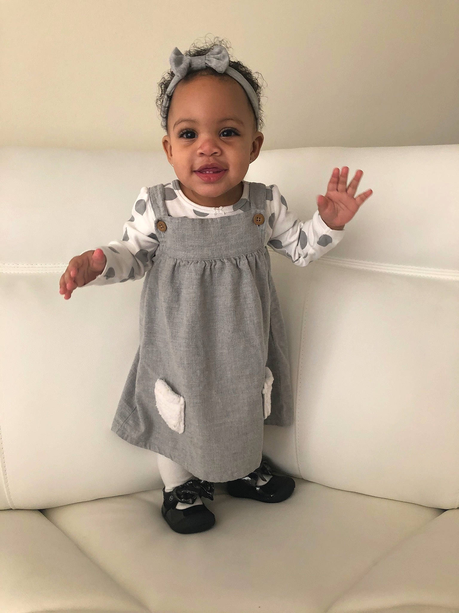 Aris joined the competition — help win amazing prizes! baby, baby_toddler_clothing, child, dress, finger, gesture, outerwear, pattern, person, room, skin, sleeve, standing, toddler, white