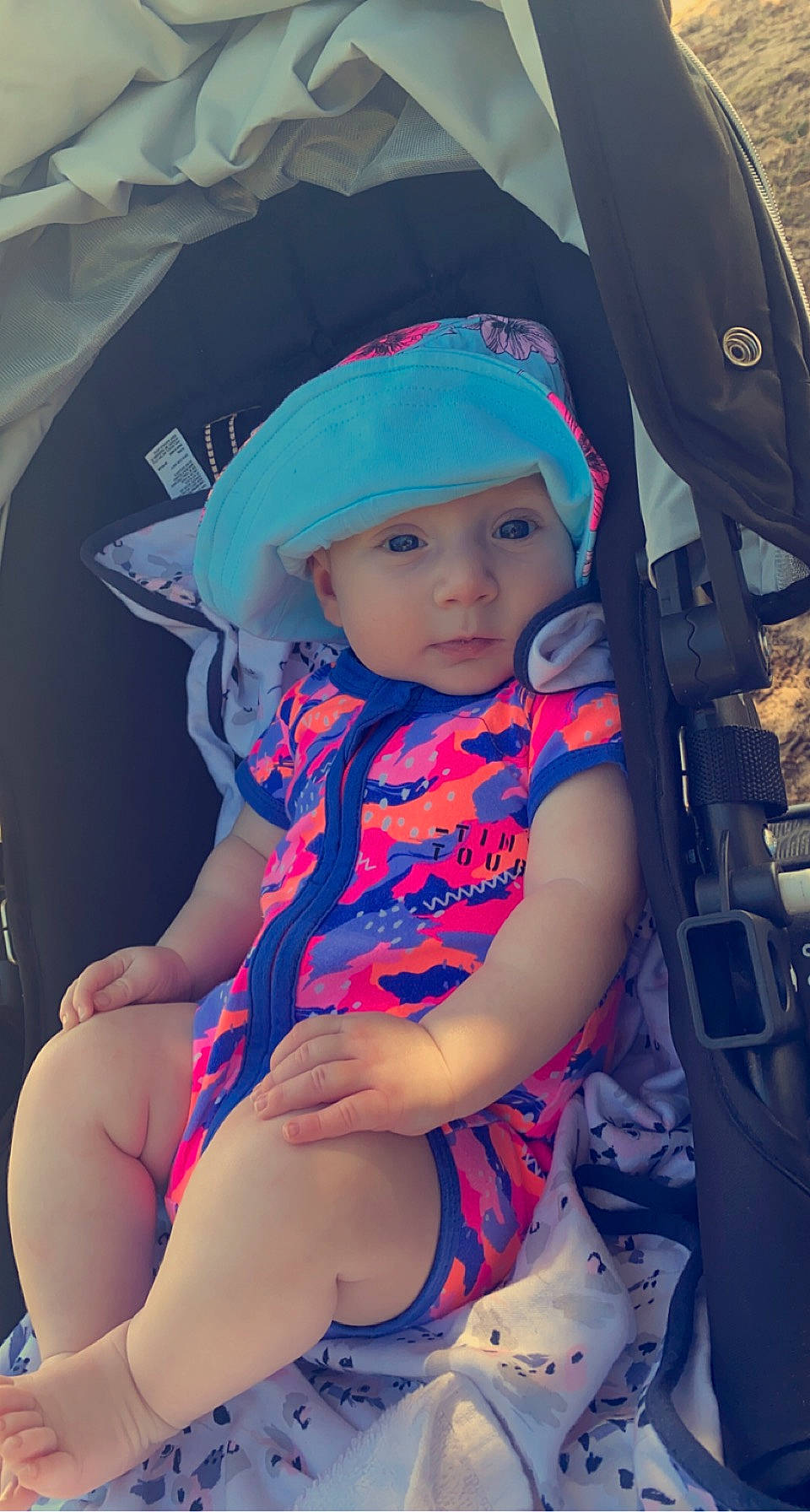 Willow is registered to the contest to win money with this photo: baby, baby_carriage, baby_toddler_clothing, beauty, cap, child, cool, electric_blue, fashion_accessory, fun, hat, headwear, human_leg, knee, lap, magenta, pattern, person, skin, thigh