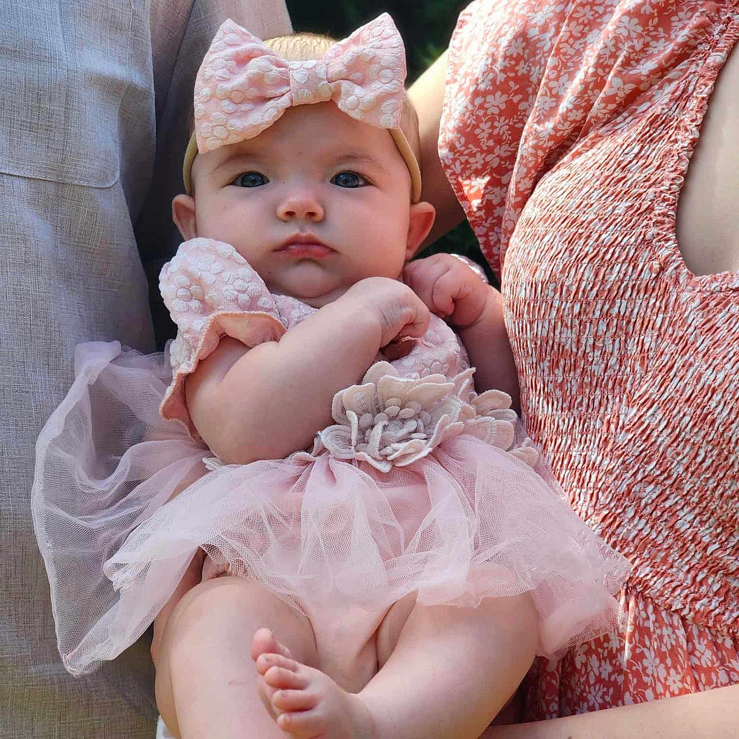 Leah joined the competition — help win amazing prizes! adult, arms, baby, bow_headband, child, closeup, cute, family, feet, happy, holding, infant, legs, nature, outdoor, pink_dress, portrait, soft_light, summer, tutu