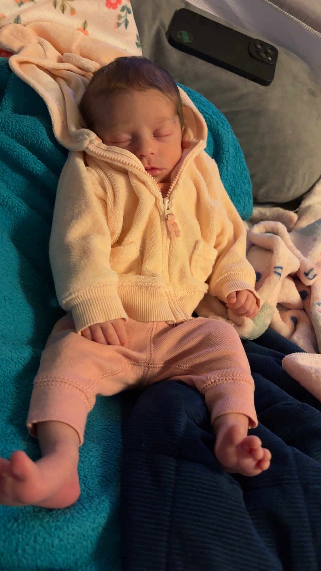 Laikelynn is registered to the contest to win money with this photo: baby, newborn, sleeping, hoodie, pink_pants, blanket, blue_blanket, cozy, indoor, soft_lighting, peaceful, child, infant, relaxing, clothing, face, hand, foot, smartphone, floral_pattern