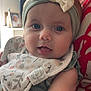 Ninon participe au concours pour gagner de l'argent avec cette photo : baby, headband, bow, blue_eyes, bib, floral_pattern, snail_pattern, arm, adult, holding, red_striped_shirt, close_up, indoor, portrait, cute, soft_lighting, skin, face, person, home