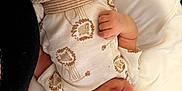 Stylles is registered to the contest to win money with this photo: baby, sleeping, infant, onesie, lion_pattern, striped_pants, hand, pillow, bed, cozy, peaceful, resting, newborn, clothing, soft, cute, portrait, child, skin, face