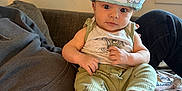 Stylles is registered to the contest to win money with this photo: baby, child, infant, hat, clothing, person, couch, indoor, window, foot, hand, sitting, cute, curious, fabric, pattern, relaxing, casual, home, portrait