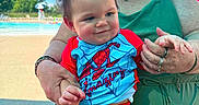 Toebias is registered to the contest to win money with this photo: adult, baby, blue_clothing, child, costume, family, outdoor, playful, pool, portrait, red_clothing, smiling, spiderman, summer, sunglasses, sunny, superhero, swimming_pool, water, woman