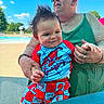 baby, child, adult, pool, swimming_pool, outdoor, sunny, portrait, smiling, spiderman, superhero, costume, red_clothing, blue_clothing, sunglasses, woman, family, summer, water, playful