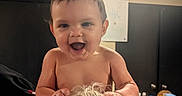 Toebias is registered to the contest to win money with this photo: baby, child, infant, smiling, laughing, portrait, indoors, home, bare_chested, short_hair, face, eyes, mouth, hands, adult, hair, playful, seated, ceiling_light, background