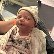 Eden is registered to the contest to win money with this photo: newborn, baby, blanket, hat, person, hospital, infant, clothing, cute, wrapped, sleepy, soft, arm, holding, indoors, bed, medical, care, comfort, newborn_clothing