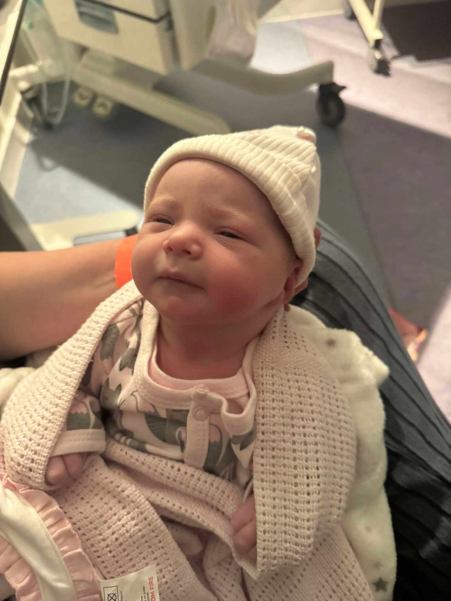 Eden is registered to the contest to win money with this photo: newborn, baby, blanket, hat, person, hospital, infant, clothing, cute, wrapped, sleepy, soft, arm, holding, indoors, bed, medical, care, comfort, newborn_clothing