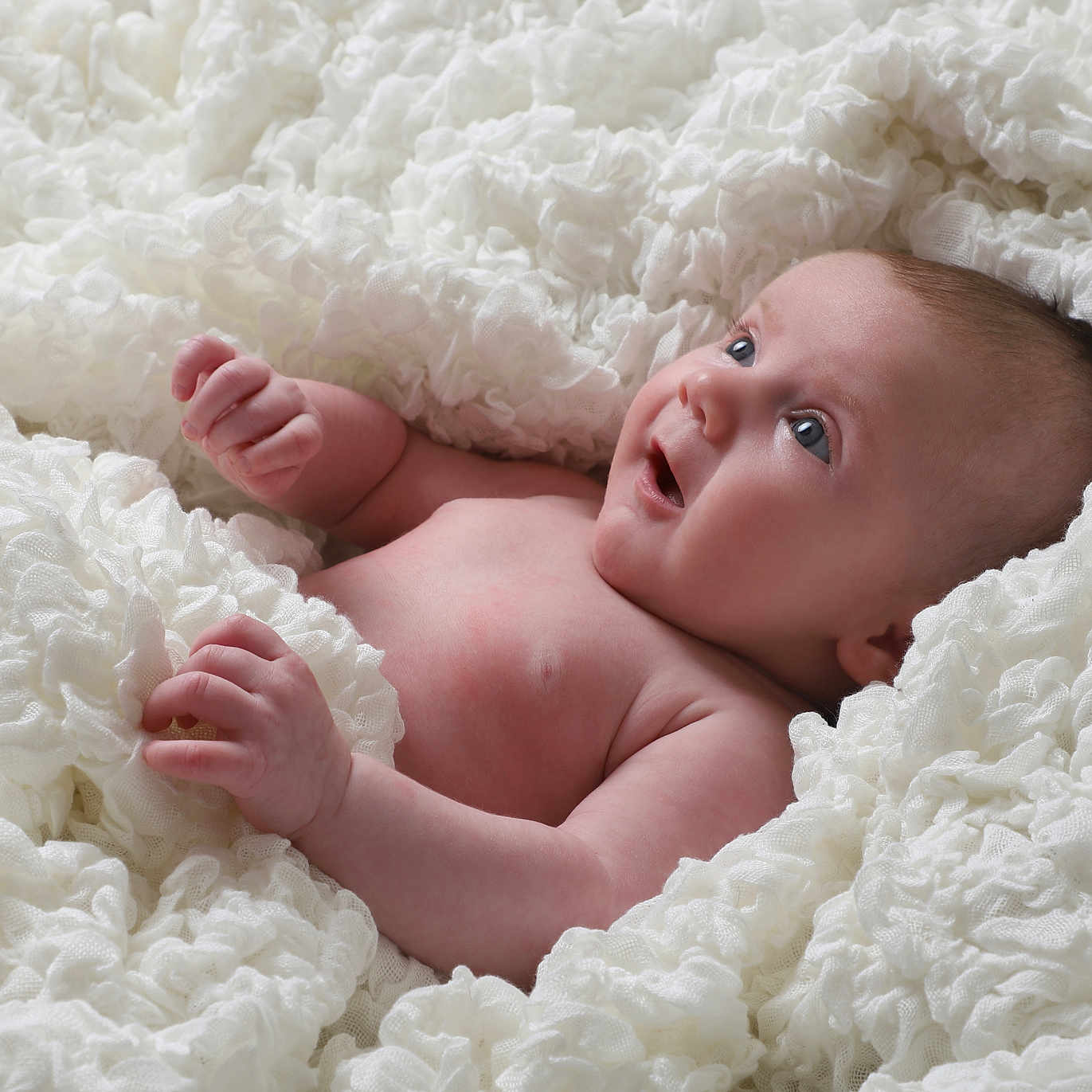 Kiah is registered to the contest to win money with this photo: baby, blanket, blue_eyes, child, comfort, cozy, cute, expression, fabric, face, hands, infant, innocence, lying_down, newborn, portrait, skin, soft_texture, white, young