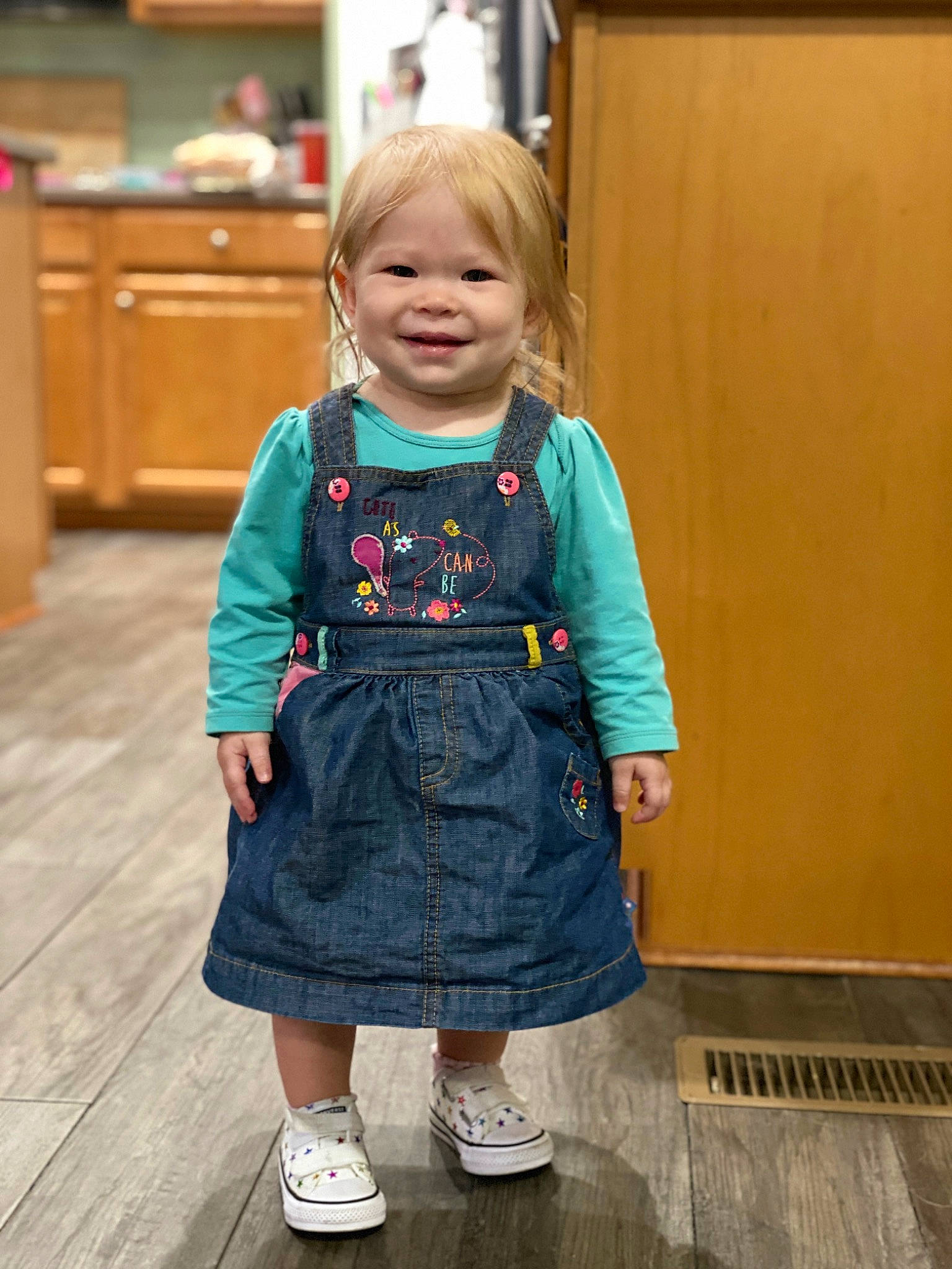 Anwyn is registered to the contest to win money with this photo: baby_toddler_clothing, cabinetry, denim, door, dress, electric_blue, event, face, floor, flooring, formal_wear, happy, head, joy, person, shoe, shoulder, skin, sleeve, smile