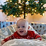 baby, child, smiling, red_sweater, blanket, christmas_tree, lights, holiday, indoor, cute, festive, happy, infant, portrait, cozy, warm, decorations, celebration, seasonal, joy