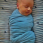 Greyson joined the competition — help win amazing prizes! newborn, baby, sleeping, swaddled, blue_blanket, striped_sheet, whale_pattern, infant, peaceful, soft_texture, wrapped, portrait, closeup, face, head, resting, cute, child, indoors, cozy