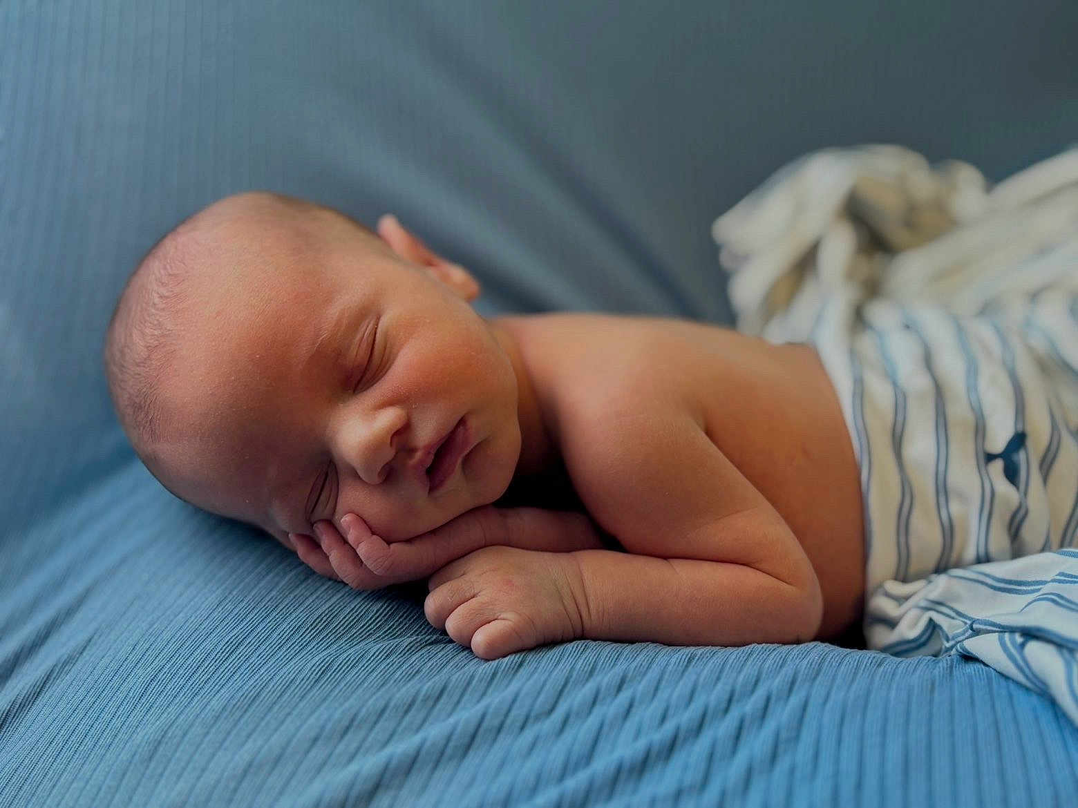 Greyson is registered to the contest to win money with this photo: newborn, baby, sleeping, peaceful, blanket, blue, striped_cloth, infant, skin, hand, face, portrait, resting, soft, cute, child, sleep, young, indoors, closeup