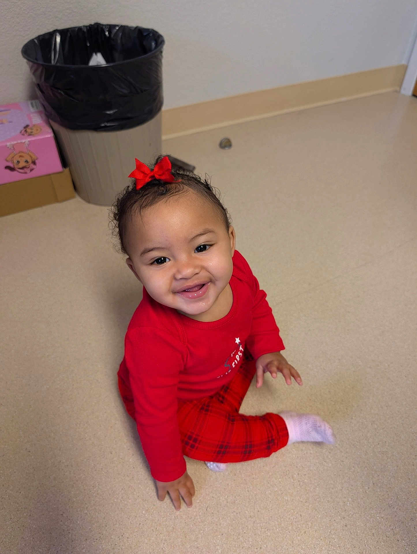 Summer joined the competition — help win amazing prizes! toddler, child, smiling, red_clothing, bow, sitting, floor, indoors, happy, person, baby, plaid_pants, sock, trash_can, box, hair, cute, portrait, young_child, playful