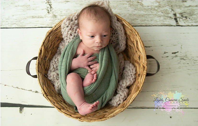 Daxton is registered to the contest to win money with this photo: baby, baby_products, baby_toddler_clothing, basket, child, comfort, fashion_accessory, grass, happy, linens, people_in_nature, person, portrait_photography, sitting, skin, thread, toddler, wicker, wood, wool