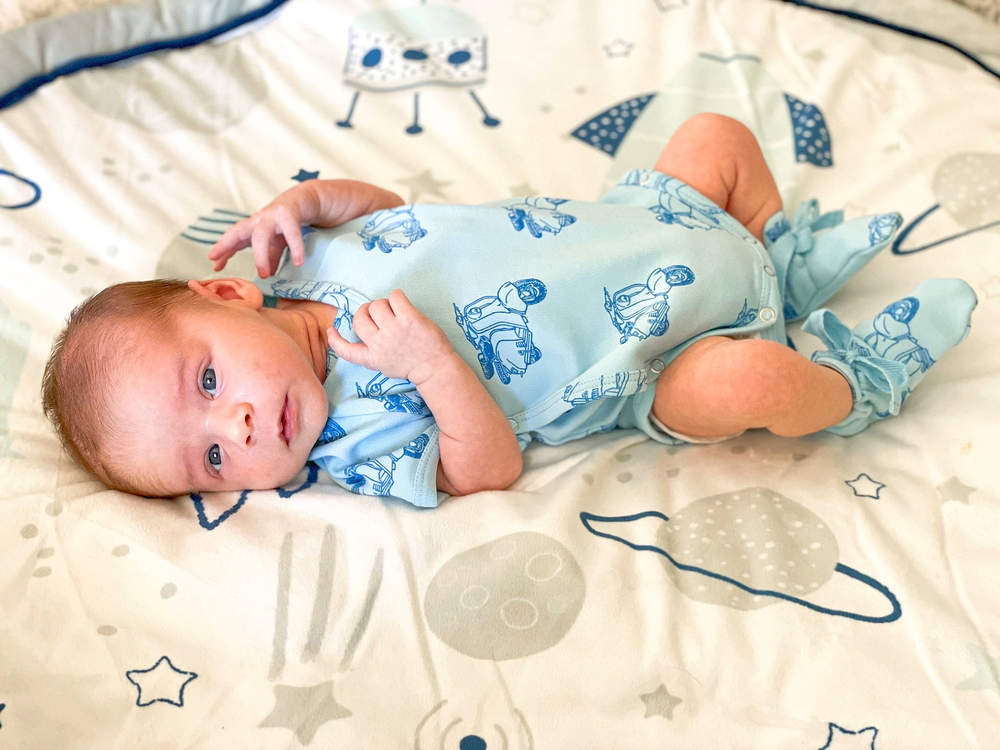 Beckham is registered to the contest to win money with this photo: azure, baby, baby_products, baby_sleeping, baby_toddler_clothing, bedding, bedtime, child, comfort, face, facial_expression, font, hat, linens, nap, pattern, person, room, skin, sleeve