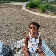 Ellen joined the competition — help win amazing prizes! toddler, child, rock, outdoor, park, nature, trees, curious, romper, clothing, barefoot, grass, daylight, ground, person, young_child, sitting, expression, summer, playground
