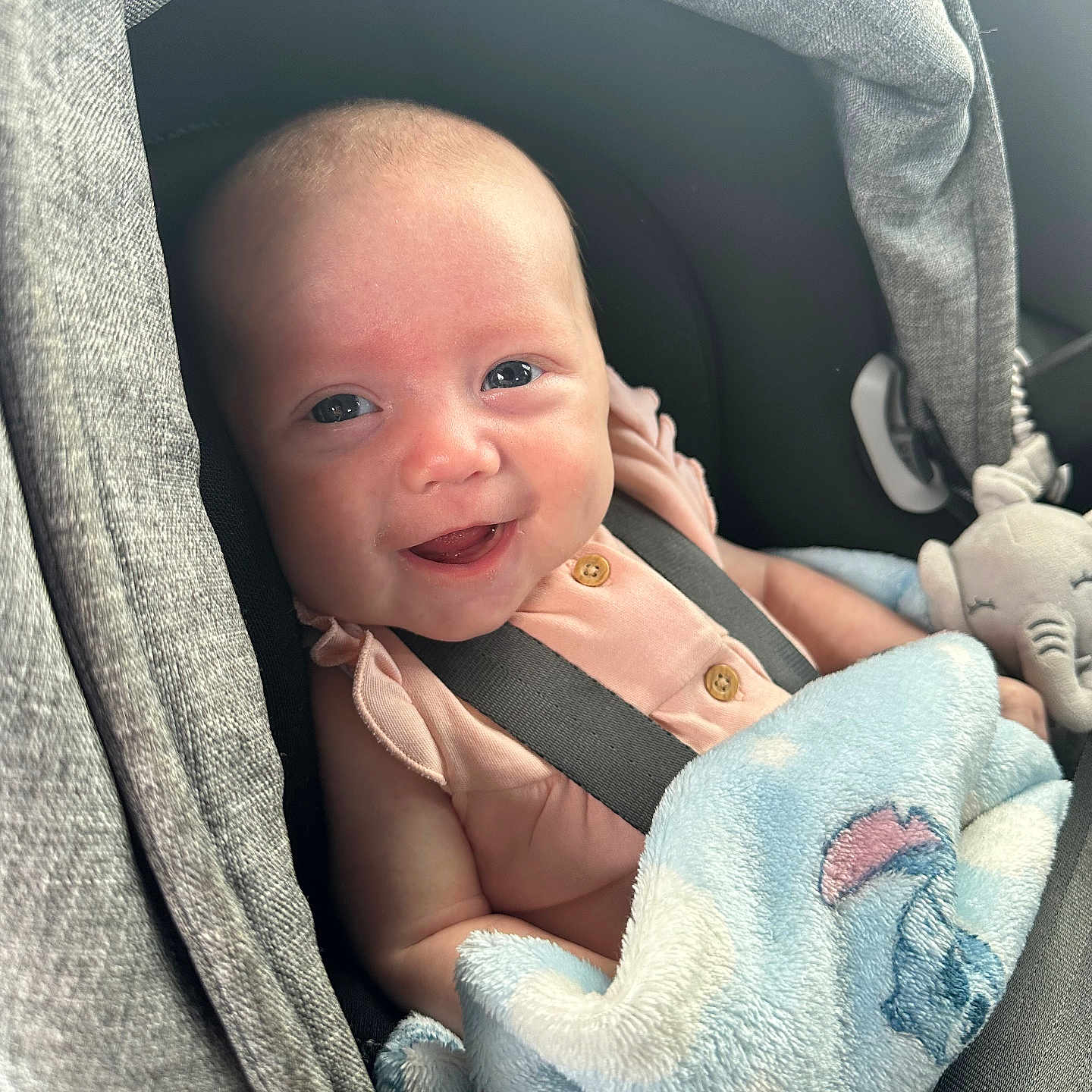 Sierra is registered to the contest to win money with this photo: baby, babylaughing, blanket, cushion, face, happy, head, homedecor, newborn, person, photography, portrait, smile, toy
