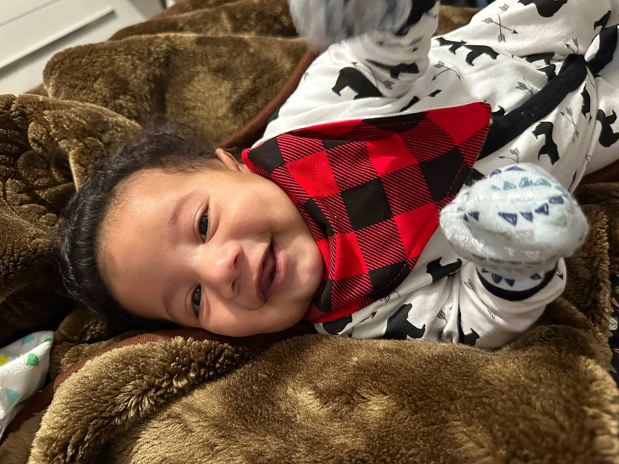 Joaquin is registered to the contest to win money with this photo: brown_hair, carmine, child, comfort, cool, flash_photography, fur, grass, happy, linens, outerwear, pattern, person, plaid, portrait_photography, sitting, sleeve, smile, tartan, textile