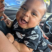 Dorian Kai is registered to the contest to win money with this photo: accessories, baby, babylaughing, bodypart, car, clothing, face, glasses, happy, head, jewelry, necklace, person, photography, portrait, smile, sunglasses, t_shirt, transportation, vehicle