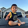 baby, toddler, child, outdoor, truck, vehicle, basketball_tank_top, sky, house, residential, curious, sitting, barefoot, daylight, expression, young_child, portrait, casual_clothing, suburb, smiling