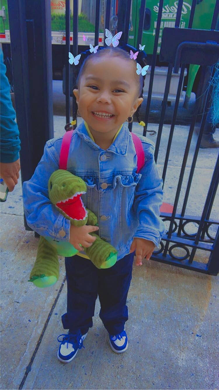 Luna is registered to the contest to win money with this photo: baby_toddler_clothing, blue, child, electric_blue, fun, happy, joy, leisure, party_supply, person, personal_protective_equipment, play, recreation, shoe, sitting, smile, sneakers, sunglasses, t_shirt, toddler