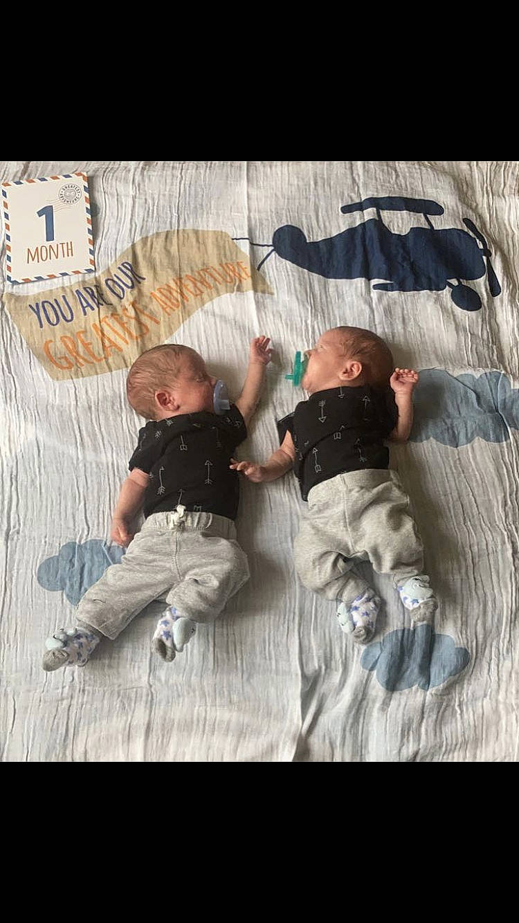 Chaselevi is registered to the contest to win money with this photo: baby, child, comfort, floor, flooring, font, fun, gesture, interaction, leg, leisure, linens, outerwear, pattern, person, sitting, sleeve, t_shirt, toddler, tree