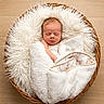 Tuff joined the competition — help win amazing prizes! baby, basket, blanket, cozy, face, fluffy, furry_texture, indoor, infant, newborn, nursery, peaceful, photography, portrait, resting, sleeping, swaddled, top_down, white_blanket, wooden_floor