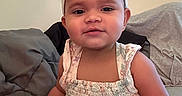 Layla Grace is registered to the contest to win money with this photo: baby, background, child, clothing, couch, cute, dress, face, hair, hand, happy, headband, indoor, person, portrait, seated, skin, smile, toddler, young