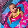 arm, baby, baby_swim, blue, child, cute, head, inflatable_pool, outdoor, patterned, person, pink, pool_float, serious_expression, skin, summer, sunlight, swimsuit, water, yellow