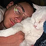 Minnie participe au concours pour gagner de l'argent avec cette photo : person, cat, sleeping, glasses, white_cat, blanket, cuddle, bedroom, cozy, rest, comfort, indoor, closeup, face, fur, peaceful, relaxation, hand, young_adult, eyewear