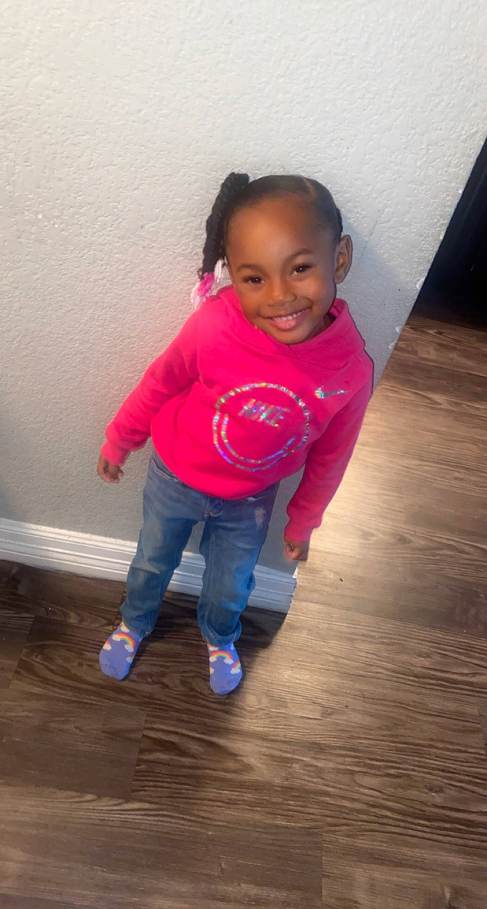 Aliyah is registered to the contest to win money with this photo: arm, baby_toddler_clothing, cheek, electric_blue, floor, flooring, fun, hair, happy, hardwood, human_body, human_leg, jeans, joy, magenta, nose, person, sitting, sleeve, smile