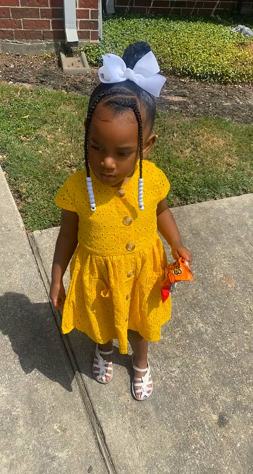 Alysia joined the competition — help win amazing prizes! asphalt, baby_toddler_clothing, child, costume, dress, event, fashion_accessory, fun, grass, happy, jewellery, leisure, necklace, person, road_surface, sandal, sidewalk, smile, toddler, tradition