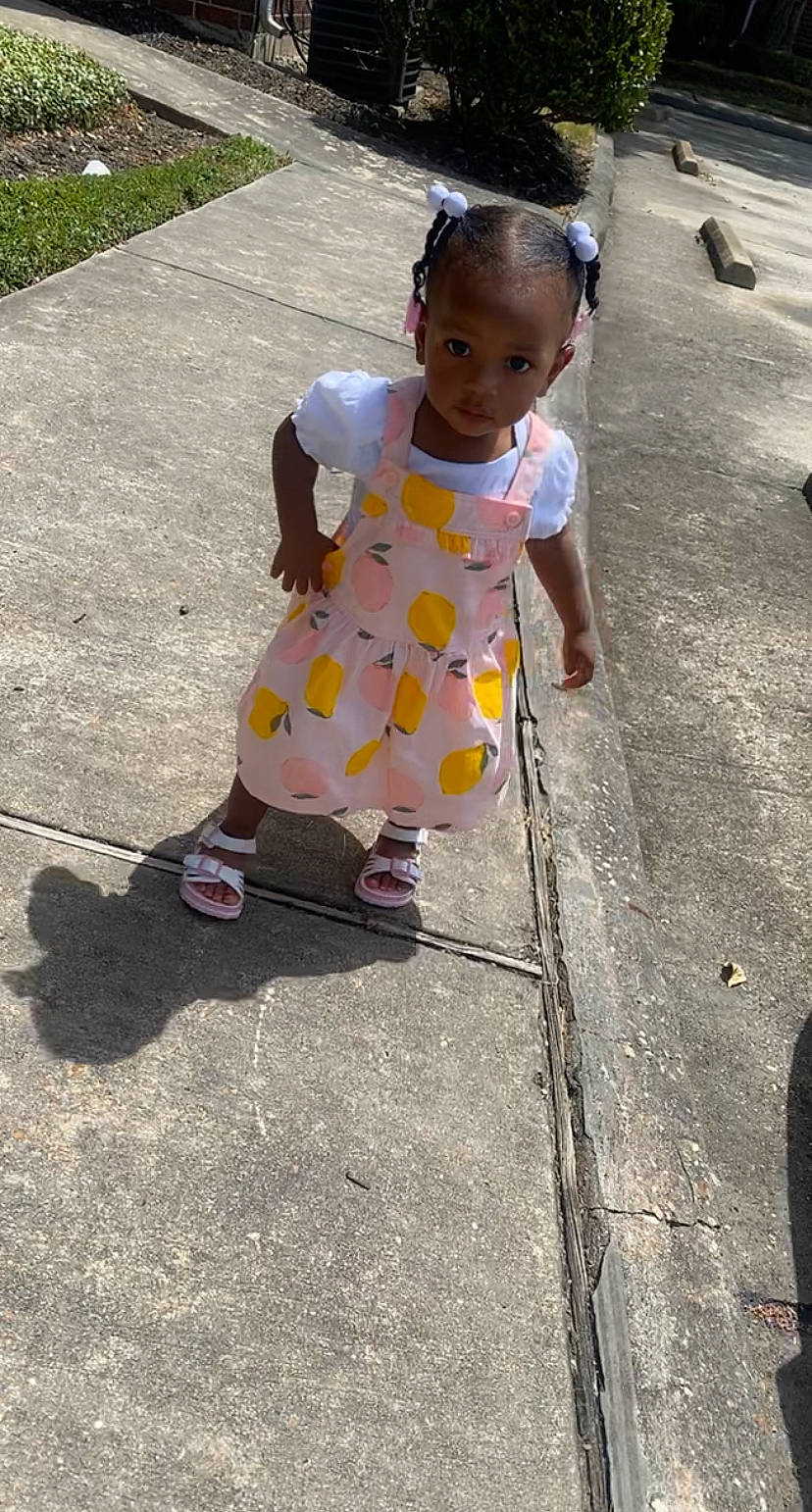 Abigail joined the competition — help win amazing prizes! asphalt, baby_toddler_clothing, child, concrete, dress, foot, fun, grass, human_leg, pattern, person, recreation, road, road_surface, sandal, shadow, sidewalk, smile, street, toddler