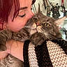 Orion a rejoint le concours — aidez-le/la à gagner de superbes lots ! person, cat, fluffy_cat, red_hair, snuggling, indoor, close_up, face, eyes, fur, hand, knitted_blanket, halloween_decor, figurines, orange, black, white, expression, cozy, affection