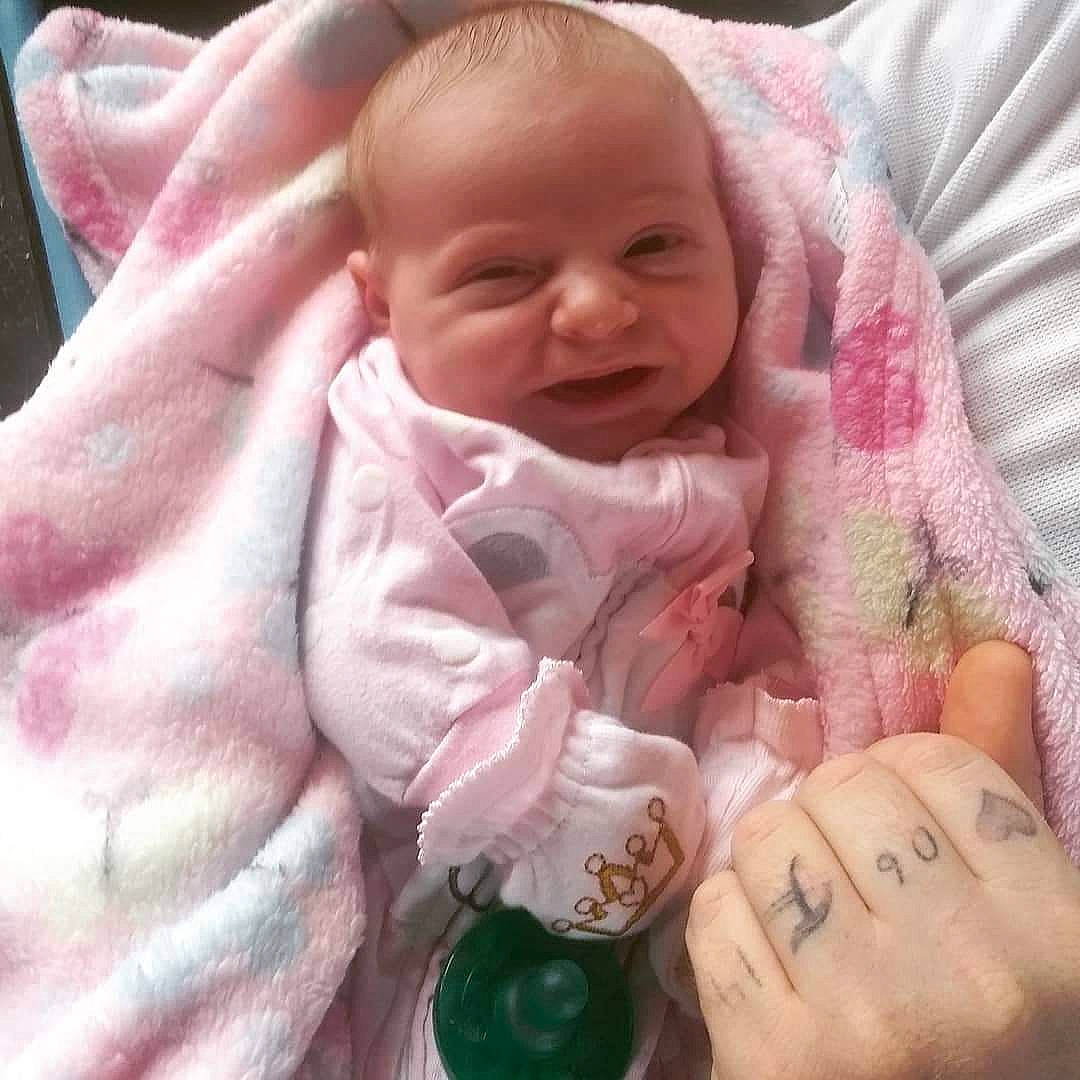 Mercy is registered to the contest to win money with this photo: baby, baby_products, cheek, child, finger, hand, head, nose, person, pink, product, skin, smile, toddler