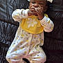 Khalani is registered to the contest to win money with this photo: adorable, baby, black_background, child, comfort, cozy, cute, daisy, floral_onesie, footed_pajamas, hair_bows, indoors, infant, lying_down, pacifier, sleepwear, small_hands, white_bows, yellow_bib, yellow_bow