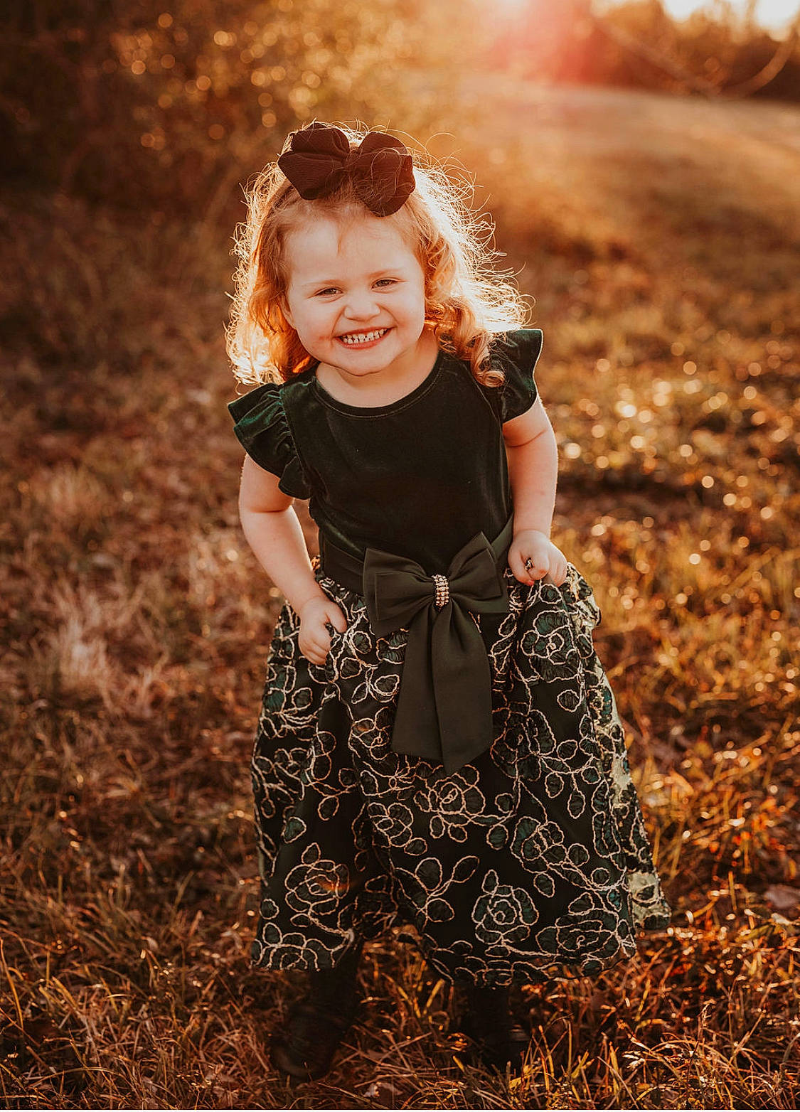 Fiona is registered to the contest to win money with this photo: baby_toddler_clothing, child, field, flash_photography, fun, grass, grass_family, grassland, happy, head, joy, landscape, pattern, people_in_nature, person, sitting, smile, soil, sunlight, tints_and_shades
