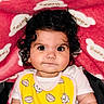 Elena a rejoint le concours — aidez-le/la à gagner de superbes lots ! baby, child, curly_hair, bib, yellow_bib, cat_pattern, pink_blanket, happy_text, cloud_pattern, cute, portrait, indoor, infant, chubby_cheeks, white_shirt, close_up, looking_at_camera, seated, soft_texture, adorable