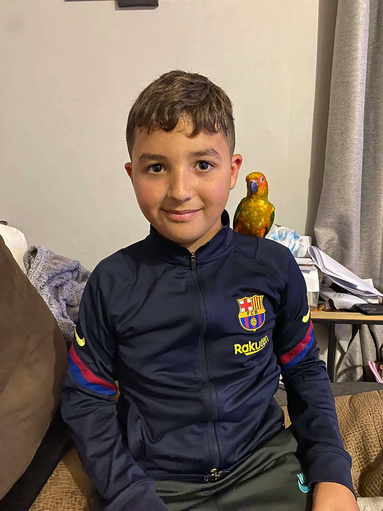 Yanis participe au concours pour gagner de l'argent avec cette photo : bird, child, comfort, curtain, fun, hoodie, jacket, joy, person, personal_protective_equipment, room, sitting, sleeve, smile, sportswear, t_shirt, toddler, toy, uniform, workwear